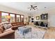 Spacious living room with a leather sectional sofa, decorative rug, and built-in bar area with seating for entertaining at 4048 Gilder Rose Pl, Winter Park, FL 32792