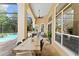 The screened patio includes an outdoor kitchen, fireplace, dining area and views of the pool at 4048 Gilder Rose Pl, Winter Park, FL 32792