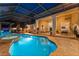 Backyard pool with spa, stone patio, bar and screened enclosure offer an outdoor oasis at 4048 Gilder Rose Pl, Winter Park, FL 32792
