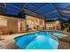 Inviting outdoor pool and spa area with stone surround and covered patio at 4048 Gilder Rose Pl, Winter Park, FL 32792
