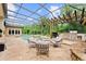 Outdoor pool area showcasing an in-ground pool, lounge seating, a covered patio, and a complete outdoor kitchen at 4048 Gilder Rose Pl, Winter Park, FL 32792