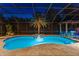 Backyard pool with spa, stone patio, and screened enclosure with mature palm trees offer an outdoor oasis at 4048 Gilder Rose Pl, Winter Park, FL 32792