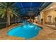 Relaxing screened-in pool area with a built-in spa, outdoor seating, and a cozy fireplace at 4048 Gilder Rose Pl, Winter Park, FL 32792
