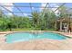 Enjoy this screened-in pool with spa, bar seating and lush, private landscaping at 4048 Gilder Rose Pl, Winter Park, FL 32792