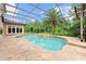 A screened-in pool features a stone surround and natural landscaping, offering a private outdoor oasis at 4048 Gilder Rose Pl, Winter Park, FL 32792