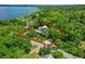Aerial view of a home surrounded by mature trees, lawn, and the property line highlighted in red at 408 W Pearl St, Minneola, FL 34715