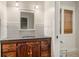 Well-lit bathroom with a granite-topped vanity and a glimpse into the adjacent water closet at 408 W Pearl St, Minneola, FL 34715