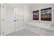 Bright bathroom with a soaking tub, window, and eye-catching black and white tile flooring at 408 W Pearl St, Minneola, FL 34715