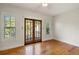 Bright bedroom featuring wood floors, neutral walls, windows and glass doors leading to a porch at 408 W Pearl St, Minneola, FL 34715