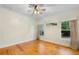 Spacious bedroom featuring hardwood floors, a ceiling fan, and good natural light at 408 W Pearl St, Minneola, FL 34715