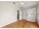 Bedroom with a large bookshelf, wood floors, neutral walls, white doors and trim at 408 W Pearl St, Minneola, FL 34715