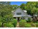 Charming two-story home featuring a landscaped yard, inviting porch, and traditional architectural details at 408 W Pearl St, Minneola, FL 34715