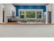 Well-lit kitchen with white cabinetry, stainless steel appliances, and a view of the backyard at 408 W Pearl St, Minneola, FL 34715
