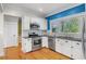 Charming kitchen boasting stainless appliances, white cabinetry, and subway tile backsplash at 408 W Pearl St, Minneola, FL 34715