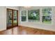 Bright living room featuring hardwood floors, large windows, and glass-paned doors at 408 W Pearl St, Minneola, FL 34715