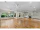 Bright, expansive living room featuring hardwood floors, recessed lighting, and a cozy fireplace at 408 W Pearl St, Minneola, FL 34715