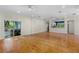Expansive living area featuring hardwood floors, access to outdoor spaces, and modern lighting at 408 W Pearl St, Minneola, FL 34715