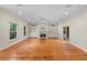 Open living space with hardwood floors, built-in shelves, and a cozy fireplace at 408 W Pearl St, Minneola, FL 34715
