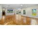 Open living area with hardwood floors and natural light, seamlessly connecting to the kitchen at 408 W Pearl St, Minneola, FL 34715