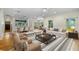 Spacious living area with hardwood floors, comfortable seating, and seamless flow into dining area at 408 W Pearl St, Minneola, FL 34715
