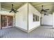 Large porch with neutral colors, ceilings fans, and wood floors at 408 W Pearl St, Minneola, FL 34715