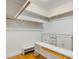 Spacious walk-in closet with custom shelving and wooden accents provides ample storage at 408 W Pearl St, Minneola, FL 34715