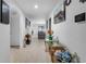 Bright hallway with modern décor, neutral paint, and tile flooring that leads to living area at 411 Ridges Dr, Dundee, FL 33838