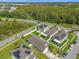 An aerial view of neighborhood homes with solar panels near green space at 4432 Desert Rose Ave, Kissimmee, FL 34746