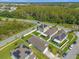 An aerial view of neighborhood homes with solar panels near green space at 4432 Desert Rose Ave, Kissimmee, FL 34746