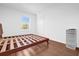 Bright bedroom featuring hardwood floors, closet, and natural light from window at 4432 Desert Rose Ave, Kissimmee, FL 34746