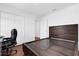 Cozy bedroom featuring hardwood floors, a modern headboard, and a comfortable workspace with a sleek desk at 4432 Desert Rose Ave, Kissimmee, FL 34746