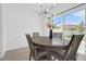 Dining room with a gray table, matching chairs, and sliding glass doors at 4432 Desert Rose Ave, Kissimmee, FL 34746