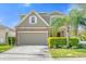 Charming two-story home featuring a stone and siding facade, manicured lawn, and attached two-car garage at 4432 Desert Rose Ave, Kissimmee, FL 34746