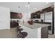 Modern kitchen with granite countertops, stainless steel appliances, pendant lighting, and a breakfast bar with stools at 4432 Desert Rose Ave, Kissimmee, FL 34746