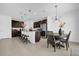 Well-designed kitchen and dining area featuring a breakfast bar, modern lighting, stainless steel appliances, and tile flooring at 4432 Desert Rose Ave, Kissimmee, FL 34746