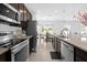 Modern kitchen with stainless steel appliances, granite countertops, and a convenient breakfast bar with an adjacent dining area at 4432 Desert Rose Ave, Kissimmee, FL 34746
