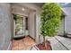 Front door entry featuring tiled flooring, a plant hanger, and decorative landscaping at 463 Warrenton Rd # 463, Winter Park, FL 32792