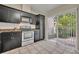 Kitchen features black cabinetry, stainless steel appliances, and sliding glass doors at 463 Warrenton Rd # 463, Winter Park, FL 32792