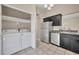 Kitchen with stainless steel appliances, tile floor, and washer and dryer at 463 Warrenton Rd # 463, Winter Park, FL 32792