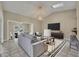 Open-concept living area featuring a sofa, large TV, and a view into the dining room at 463 Warrenton Rd # 463, Winter Park, FL 32792