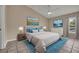 Bright main bedroom with tile floors, ceiling fan, and large windows at 463 Warrenton Rd # 463, Winter Park, FL 32792
