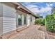 Brick patio featuring glass doors and privacy fence with lush landscaping at 463 Warrenton Rd # 463, Winter Park, FL 32792