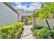Beautiful walkway to front door with lush landscaping and mature trees at 463 Warrenton Rd # 463, Winter Park, FL 32792