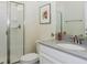Clean bathroom with vanity, grey countertop, framed art, and a glass door shower at 4912 Windermere Ave, Kissimmee, FL 34746