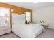 Bright bedroom with gold accent wall, white furniture and carpeted floors at 4912 Windermere Ave, Kissimmee, FL 34746