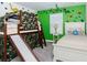 Playful bedroom with unique bunk bed slide, fun wall decals and a charming decor at 4912 Windermere Ave, Kissimmee, FL 34746