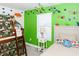 Fun bedroom featuring a bunk bed, slide, dinosaur wall decals, and comfortable furniture at 4912 Windermere Ave, Kissimmee, FL 34746