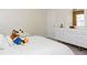 Bright bedroom featuring neutral walls, modern white dresser and a comfortable bed at 4912 Windermere Ave, Kissimmee, FL 34746