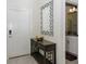 Welcoming entryway featuring a modern mirror, stylish console table with decor, and a glimpse into the adjacent bathroom at 4912 Windermere Ave, Kissimmee, FL 34746