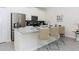 Modern kitchen with stainless steel appliances, sleek white cabinetry, and a breakfast bar with seating, ideal for casual dining at 4912 Windermere Ave, Kissimmee, FL 34746